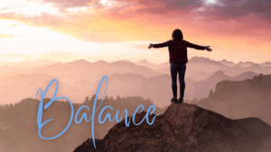 Person standing on mountain peak with outstretched arms practicing balance. The word BALANCE is featured overlaid on image