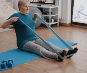 woman using band to stretch on yoga mat